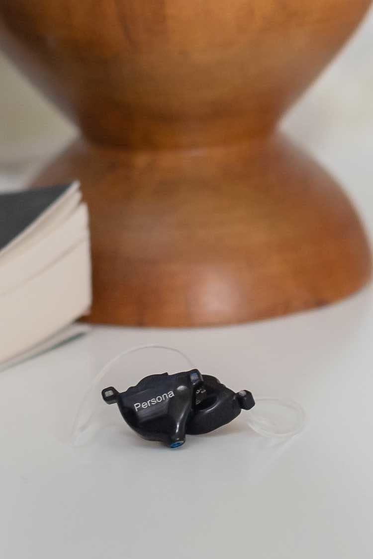 2 Ole 2 hearing aids on beside table